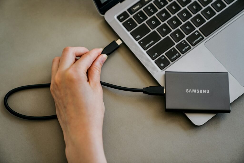 Person plugging a charger into a laptop to check battery and charging