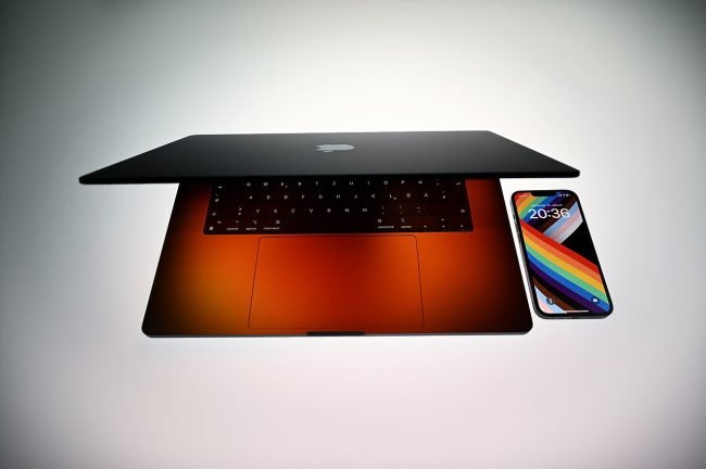 16-inch MacBook Pro next to an iPhone 13 Pro for size scale