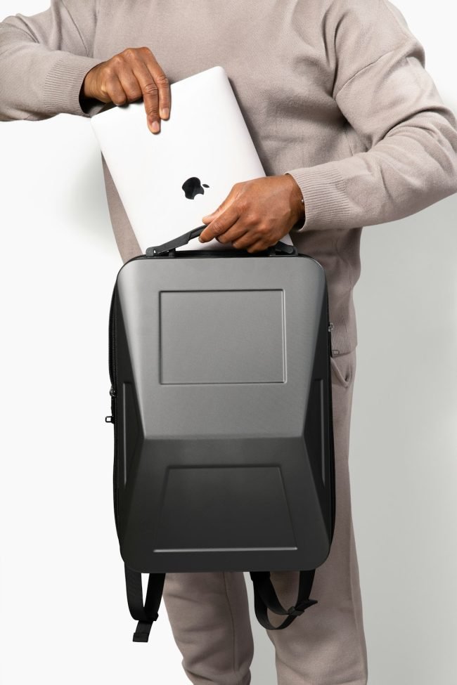 Person putting a laptop into a backpack